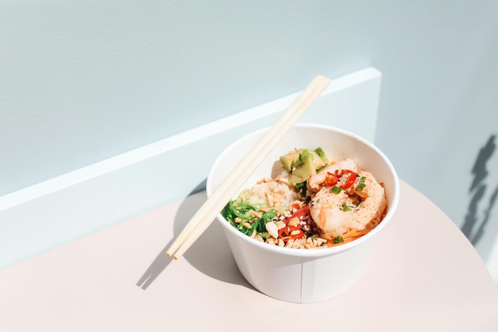 Bright and appetizing Hawaiian poke bowl with shrimp and vegetables in a minimal setting.